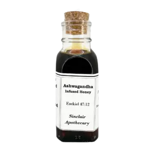 Small glass bottle of Ashwagandha Infused Honey with a cork, labeled Sinclair Apothecary, on a white background.