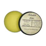 Handcrafted Calendula Salve in a black tin featuring natural ingredients for skin healing - calendula-salve-caster-olive-oil-bees-wax-heal-wounds-rashes-dry-skin_1x1_isolate-1.webp