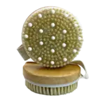 Round dry brush with wooden handle, soft bristles, and skin-stimulating nubs for exfoliation.