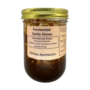 Jar of fermented garlic honey with cinnamon, promoting immune support, from Sinclair Apothecary.