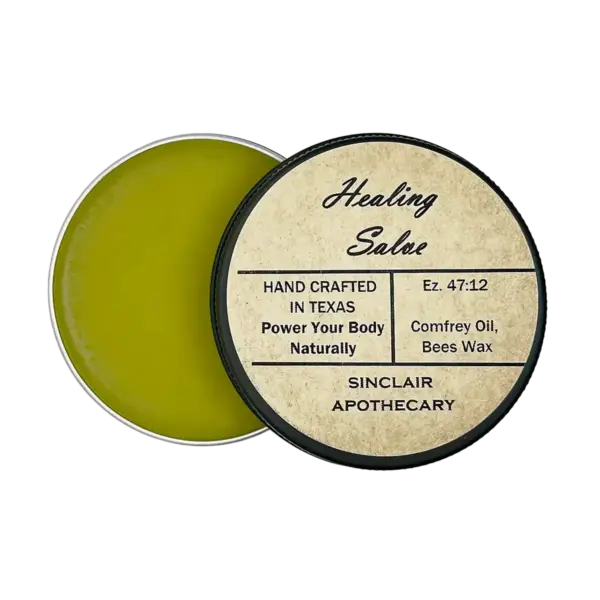 Open tin of handcrafted healing salve with comfrey oil and beeswax, eco-friendly packaging.