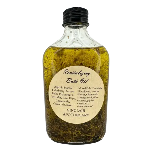 Bottle of Sinclair Apothecary organic revitalizing bath oil with herbs, flowers, and infused oils.
