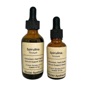 Two amber bottles of spirulina tincture with dropper tops, labeled for health benefits, on a white background.